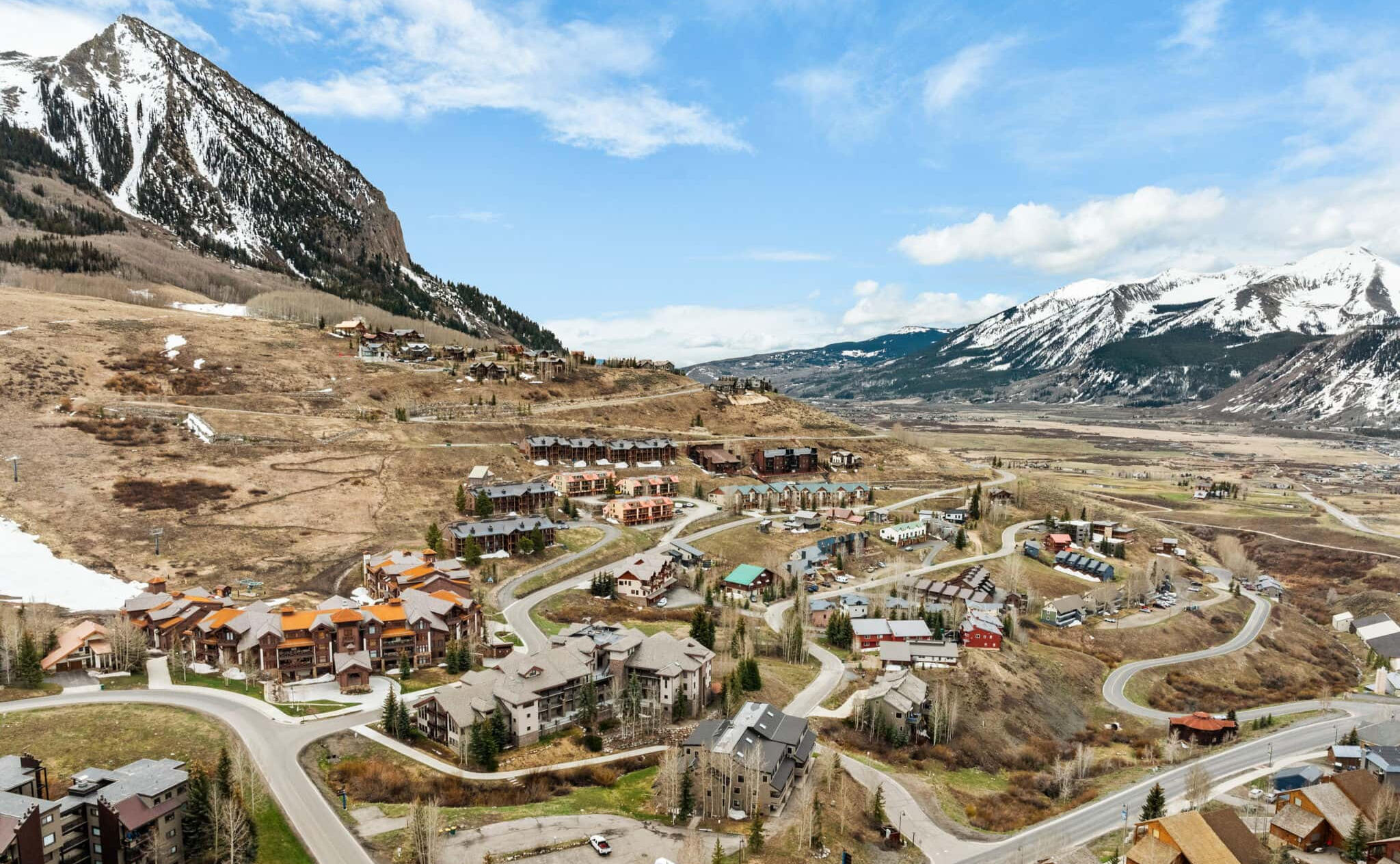 False Summit CB at the Base of Crested Butte Mountain Aerial view of Mt. Crested Butte base area and False Summit CB condo building below the Crested Butte peak