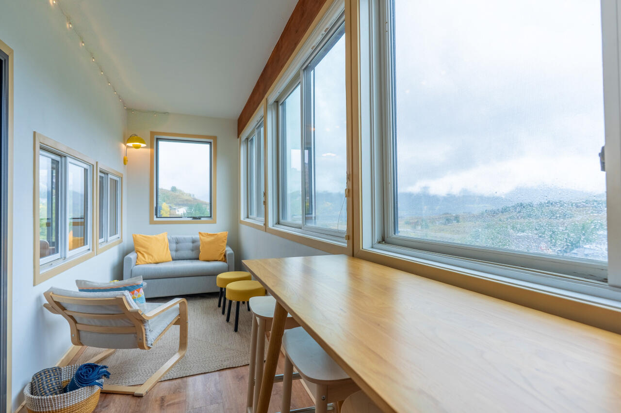 Sunroom with Alpine Views Sunroom of a Mt. Crested Butte vacation rental condo with large windows looking out on the mountains on an overcast day